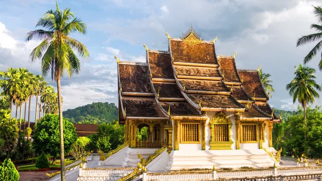 Luang Prabang, Laos. Famous temple in Luang Prabang, Laos with cloudy sky. Time-lapse in the sunny evening
