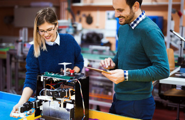 Young students of robotics working on project