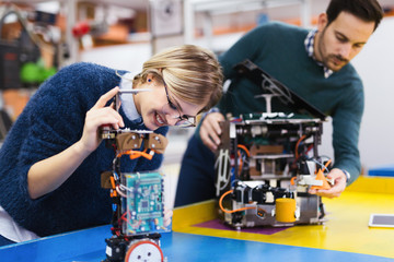 Young students of robotics working on project