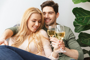 Happy young loving couple drinking alcohol white wine champagne.