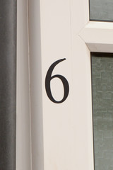 House number 6 sign on wall