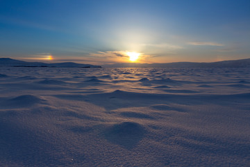 Winter landscape. Beautiful sunset in the Lake Baikal