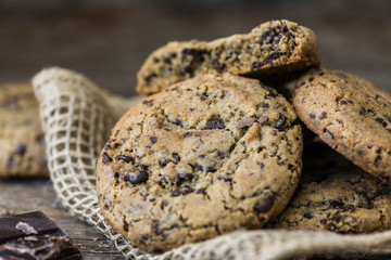 A Heap of Freshly Baked Chocolate Cookies on Rustic Wooden Table. Sweet Biscuits. Homemade pastry.