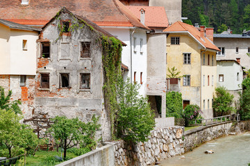 Fototapeta na wymiar Street A small town in the mountains of Slovenia, Europe. Shabby old houses facades, and roofs