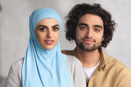 Portrait Of Muslim Couple Looking At Camera At Home