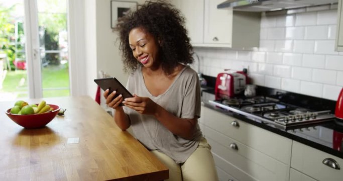An attractive woman does her online shopping on her digital tablet
