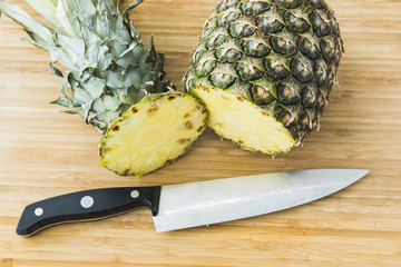 closeup cutting a pineapple on wooden background