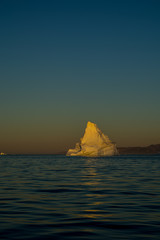 Iceberg in sun light. Sunrise in Greenland.