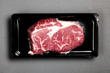 Raw steak in an airtight packaging