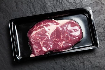 Papier Peint photo autocollant Steakhouse Raw steak in an airtight packaging