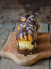 Tasty muffins on a wooden cutting board on a cake background, close-up, cupcakes black and white, chocolate and vanilla, zebra cake for breakfast or a family picnic.