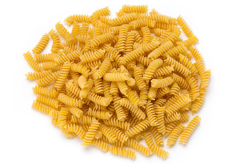 Uncooked fusilli pasta isolated white background.