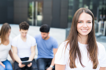 Fototapeta premium Woman in front of a group of friends