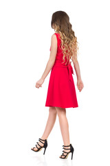 Walking Woman In Red Dress And High Heels. Rear Side View.