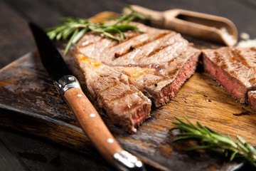 Grilled steak on wooden cutting board