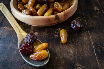 Dates on a wooden spoon and on a wooden plate