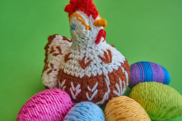 Knitted hen and colorful Easter eggs
