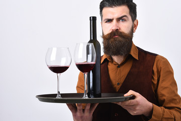 Man with beard holds alcohol on white background