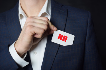 Businessman shows business card with the inscription:HR