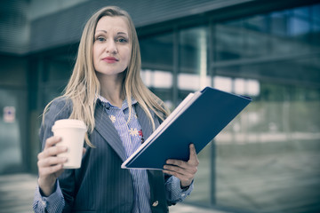 Professional woman in jacket with coffee