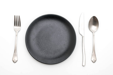 empty plate spoon fork and knife