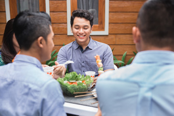 friends enjoying meal at outdoor party