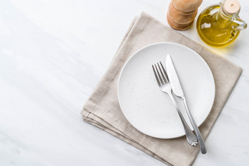 empty plate spoon fork and knife