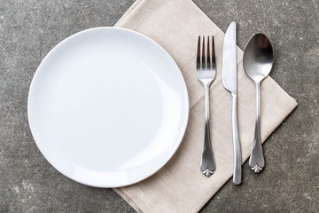 empty plate spoon fork and knife