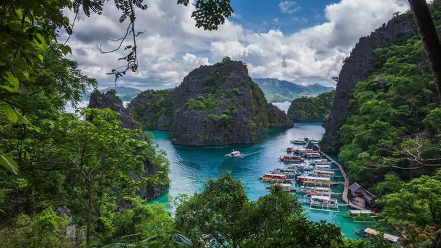 Coron island, Palawan, Philippines, time lapse view of Kayangan Lake viewpoint showing tourist outrigger boats and karst scenery. Zoom in.