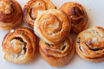 Buns of puff pastry. Curly buns with cheese. Cheese baked puff pastry.