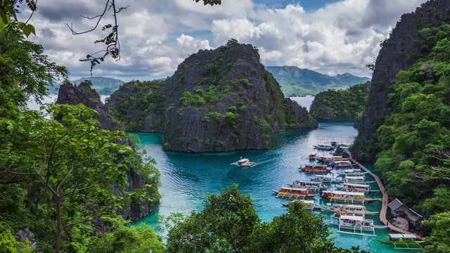 Coron island, Palawan, Philippines, time lapse view of Kayangan Lake viewpoint showing tourist outrigger boats and karst scenery. 