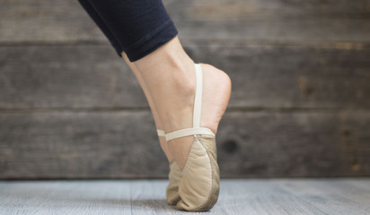 gymnasts feet in the toes on wooden background