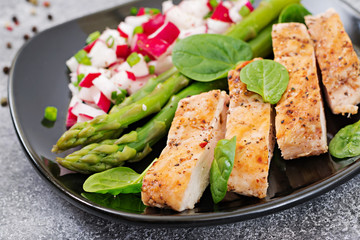Chicken fillet cooked on a grill with a garnish of asparagus and radish salsa. Dietary menu. Healthy food