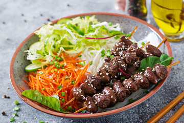 Chicken hearts in spicy sauce, noodles and vegetable salad. Healthy food.