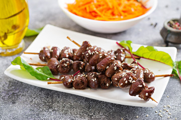 Chicken hearts in spicy sauce and carrot salad. Healthy food.