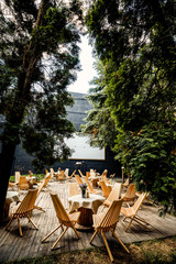 Picnic table with beautiful bouquet of pink peony on it and chai