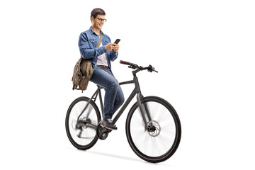 Obraz premium Young man riding a bicycle and using a phone