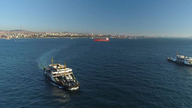 Ships floating Bosphorus blue water sunny day. Aerial drone view on sunset in Istanbul, Turkey