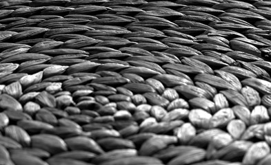 Round straw mat texture with blur effect in black and white.
