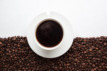 Coffee cup on half coffee beans and half white background