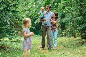 Young happy family walking in the park.