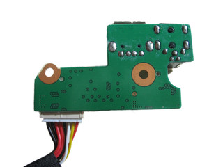 Isolated macro of a green computer circuit board with wiring harness