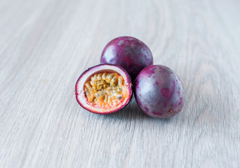 Passion fruit on wooden background. Sliced exotic fruit