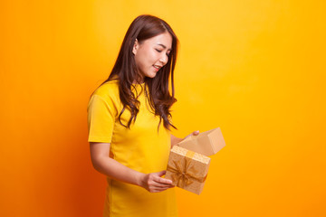 Young Asian woman open a gift box.