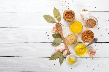 Assortment of mustard in sauces. Spices On a white wooden background. Top view. Copy space for your text.