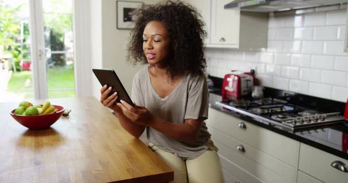 An attractive woman video chatting on a digital tablet