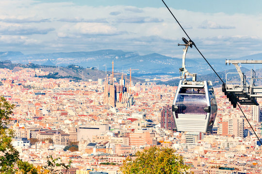 Cable car to Montjuic hill. Cityscape of Barcelona. Sagrada Familia.