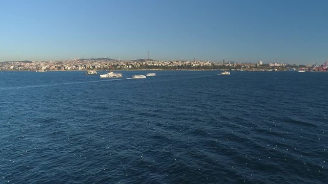 Ships floating Bosphorus blue water sunny day. Aerial drone view on sunset in Istanbul, Turkey