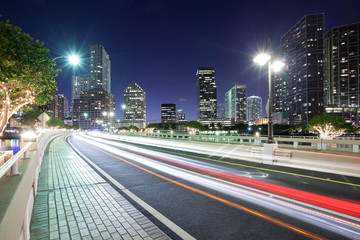 Fototapeta na wymiar Streaking lights on Brickell key Drive with Brickell district skyline, Miami, Florida, USA