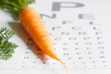 Carrot vitamin A and eye test chart healt medical  concept
